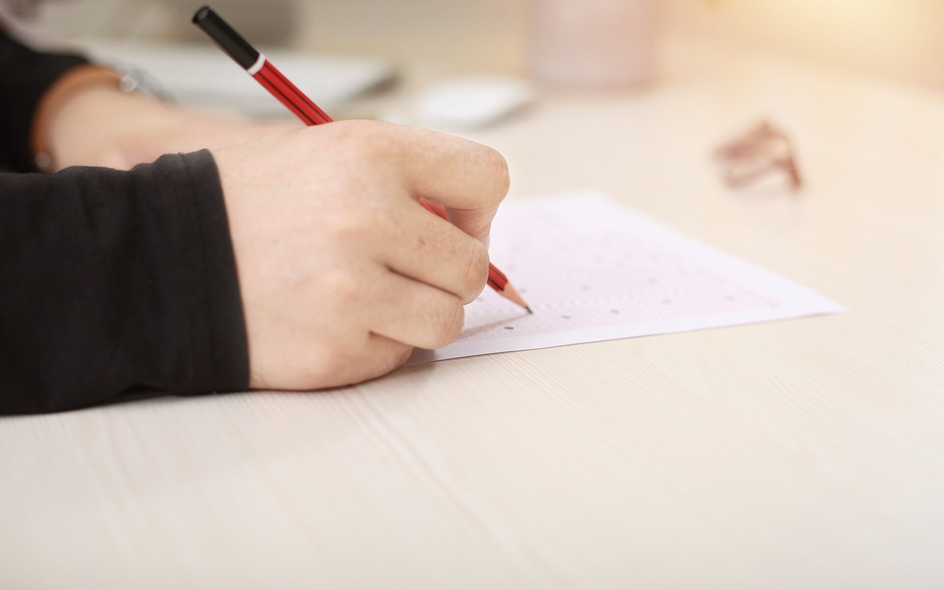image of someone writing on a piece of paper
