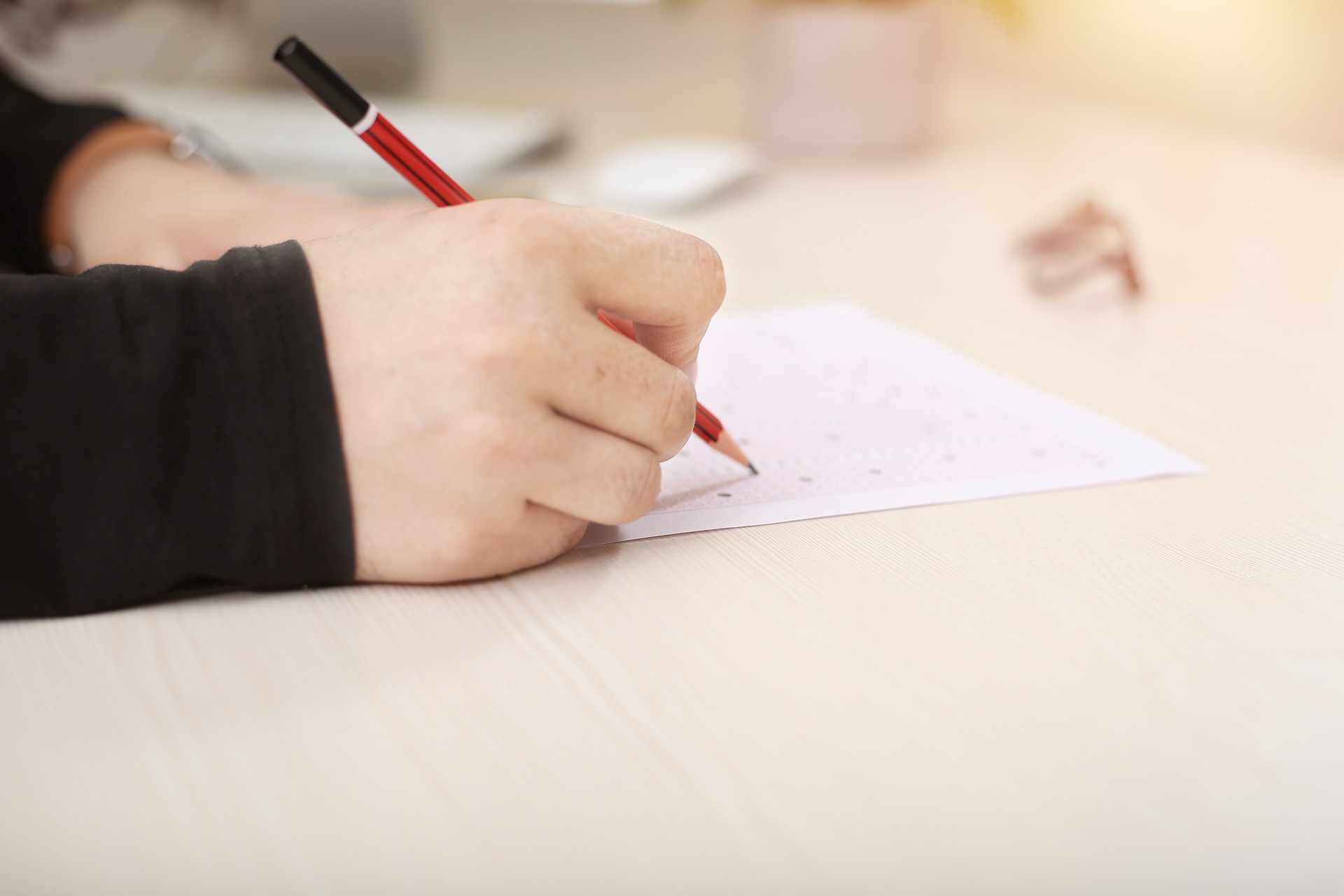 image of someone writing on a piece of paper