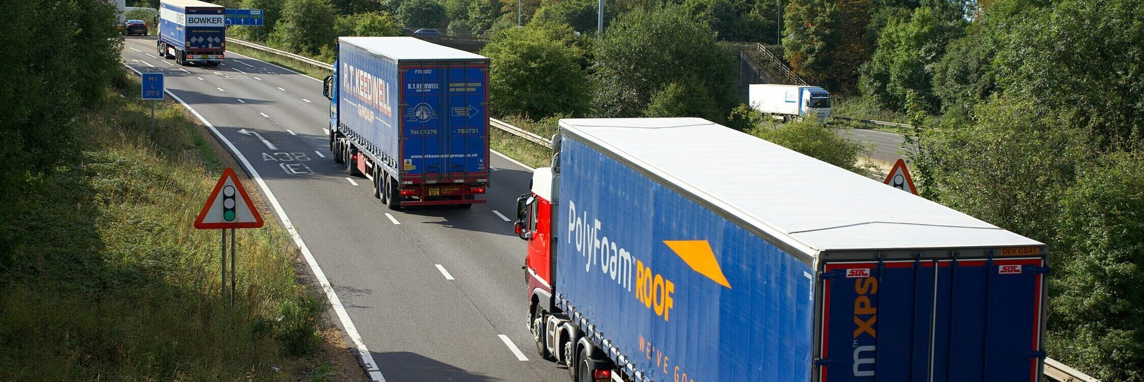 image of three hgv vehicles driving on the road